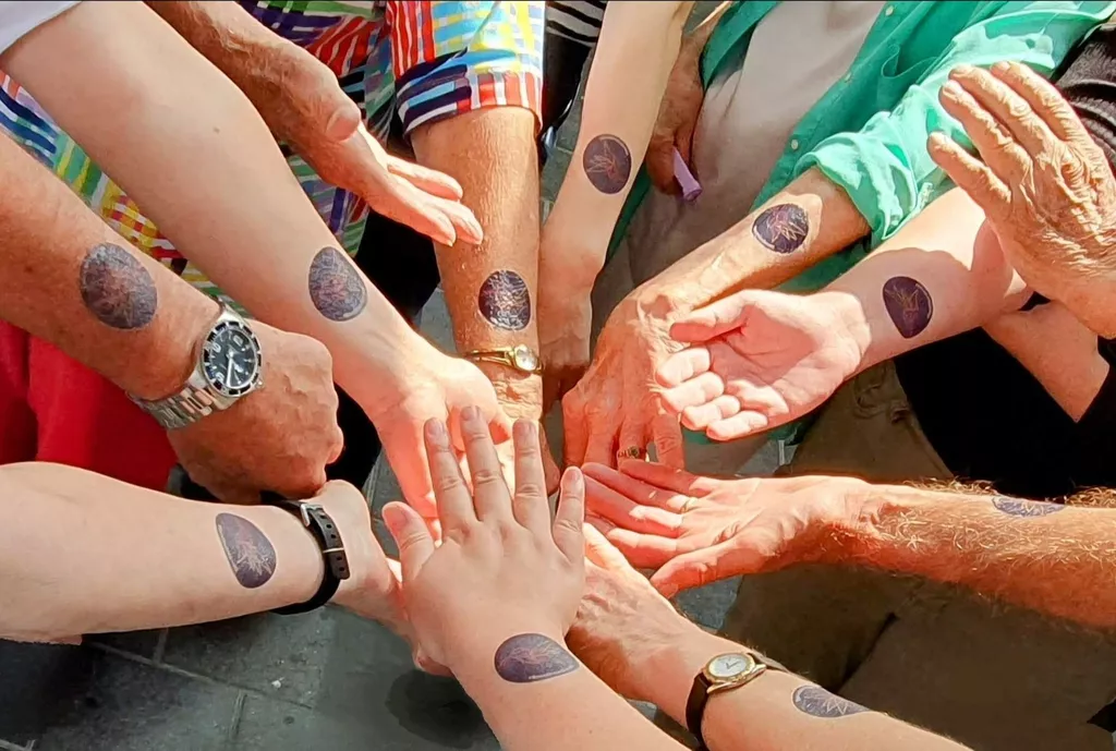 Hands displaying tattoos supporting rare